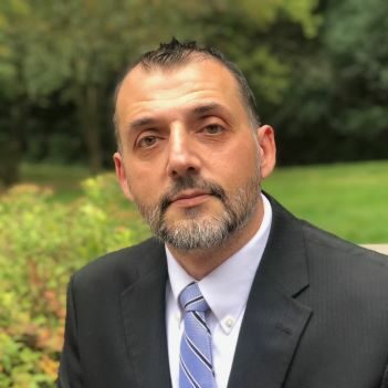 Man in suit with striped tie outdoors