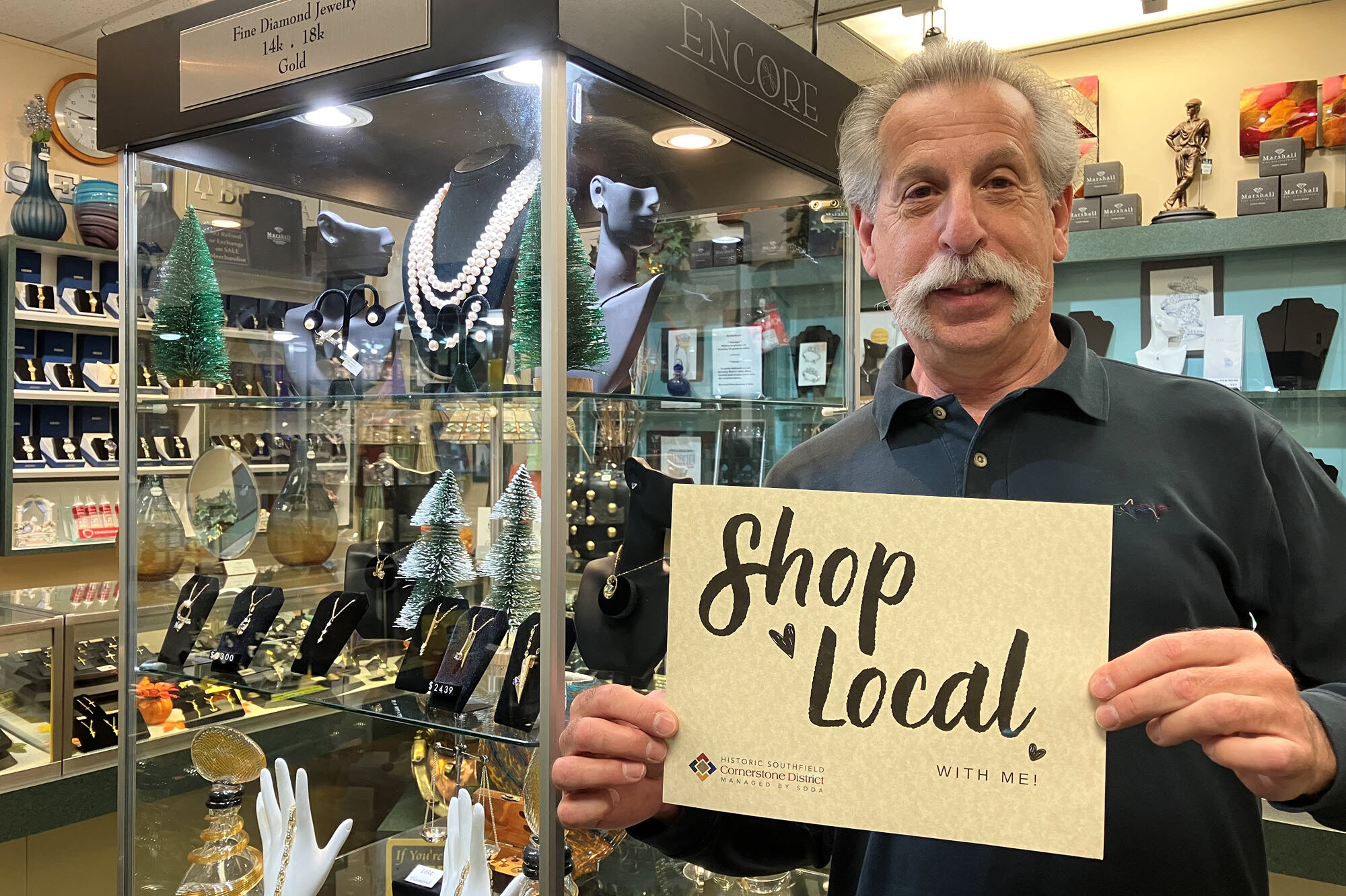 Man promoting local jewelry store.
