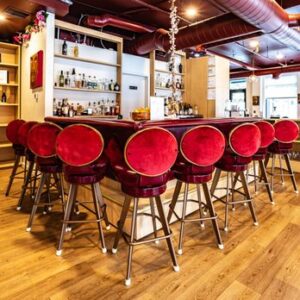 Modern bar with red velvet stools