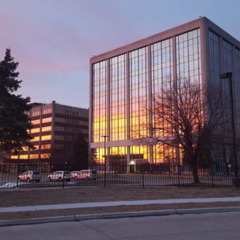 Office buildings reflecting sunset in glass windows